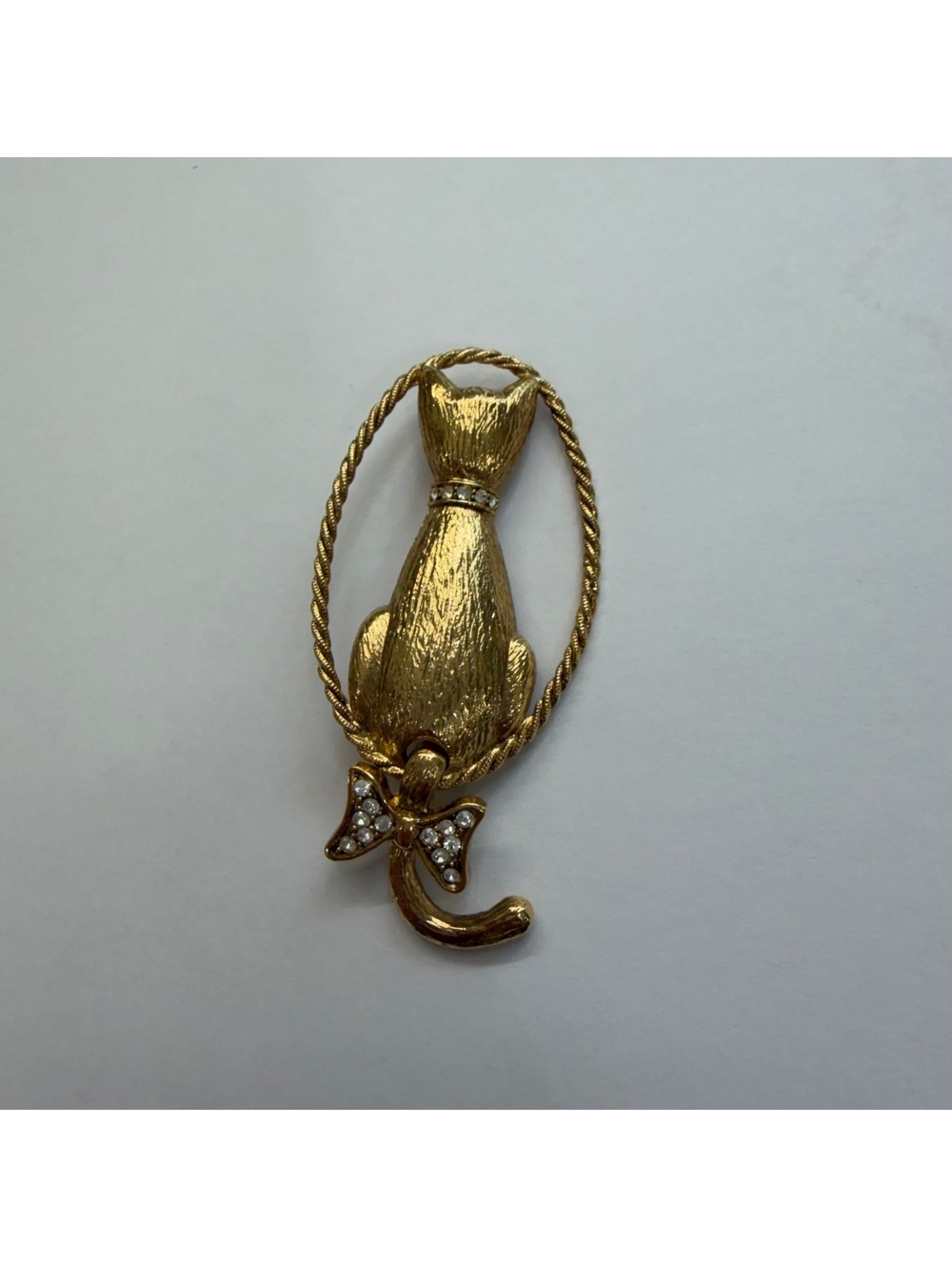 1928 cat brooch with rhinestone accents and articulating tail
